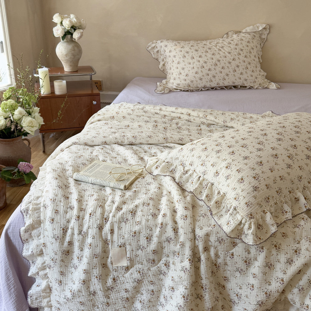 Detailed shot of floral cotton comforter’s gauze fabric and delicate ruffled edge