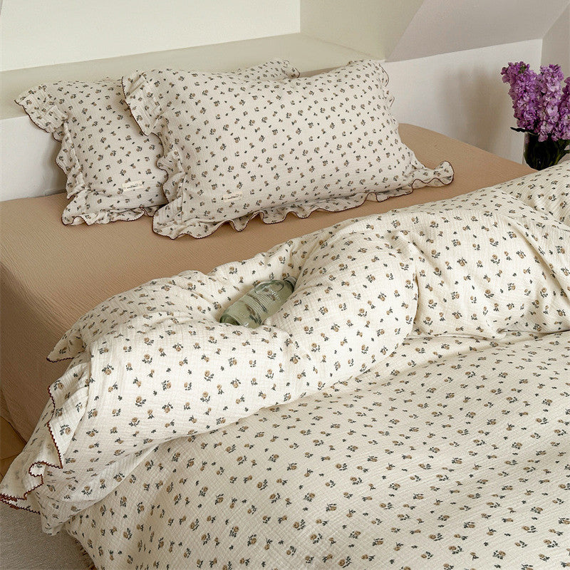 Full size Rose Floral Duvet Cover and two ruffle pillow shams on a neutral-colored sheet.