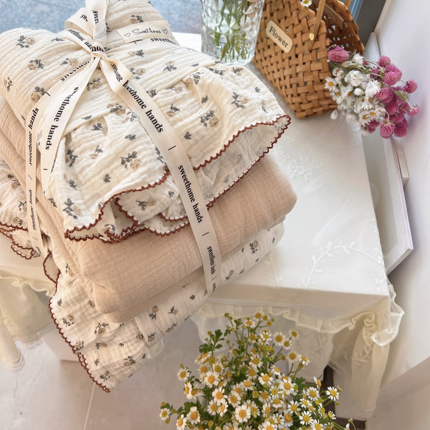 Stacked Ruffled Rose Floral Duvet Cover Set (cotton gauze) folded for presentation with a ribbon and flowers.