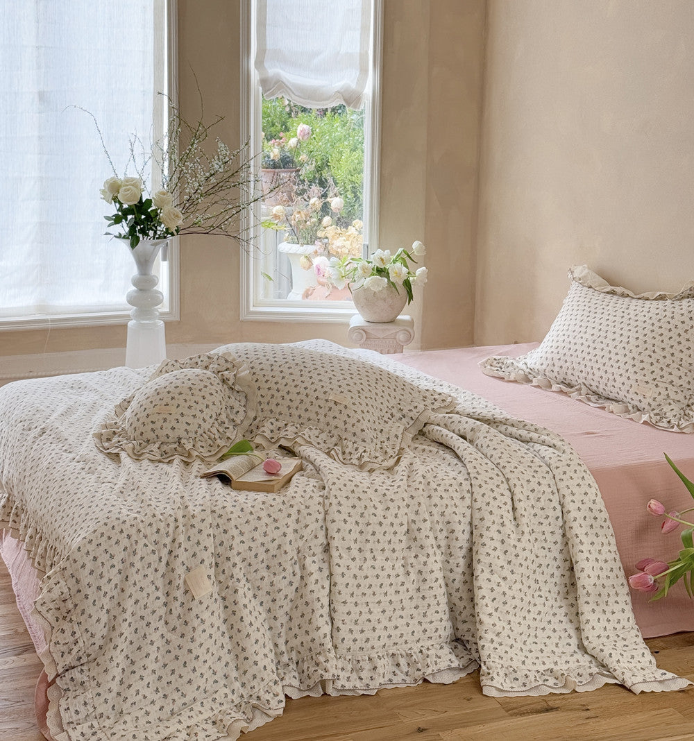 Lightweight pink rosebud comforter on bed in sunny room