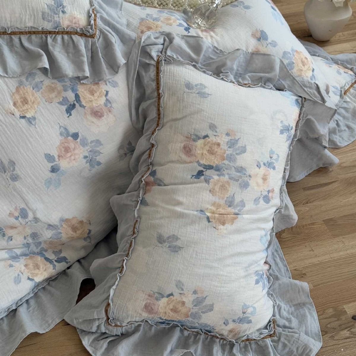 Ruffled pillowcases with dusty blue floral gauze design