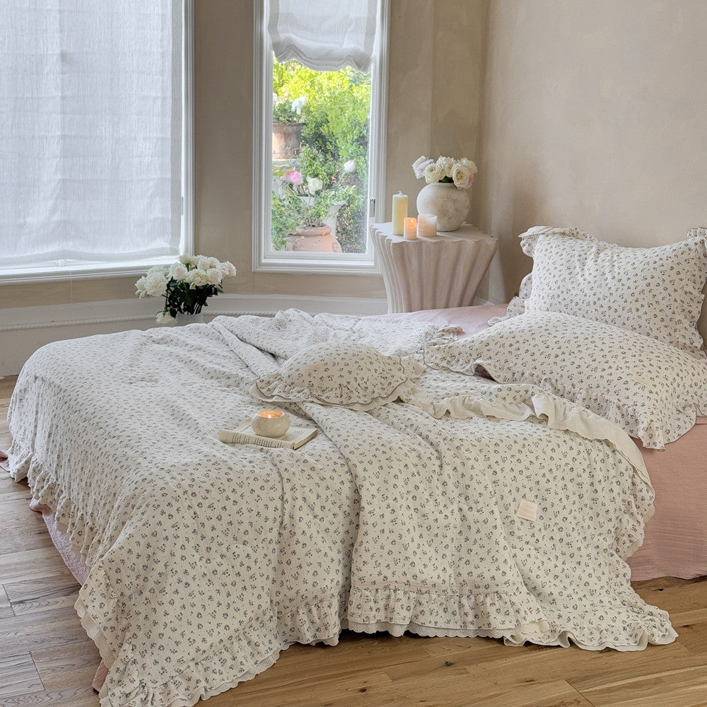 Cottagecore bedding scene featuring a floral ruffled comforter styled in a natural-lit bedroom