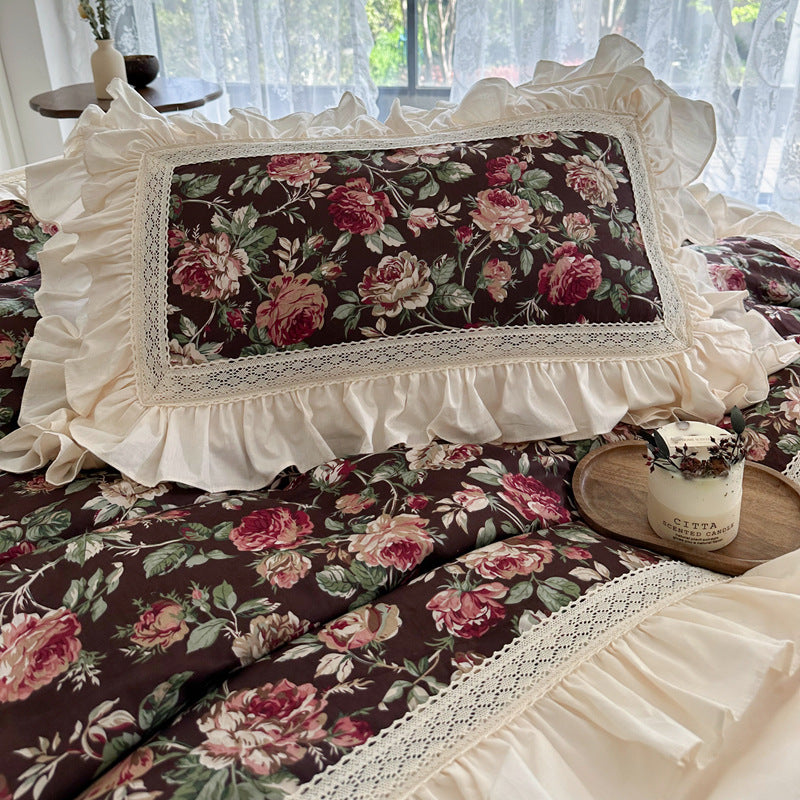 Pillow detail from dark floral ruffled cotton bedding set