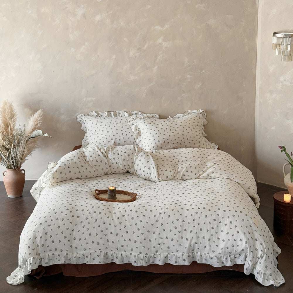 A wide shot of a Queen-size bed with the Wild Pansy duvet cover set, showing the full bedding set in a natural light setting with a tray and a decorative plant, creating a complete and inviting bedroom scene.