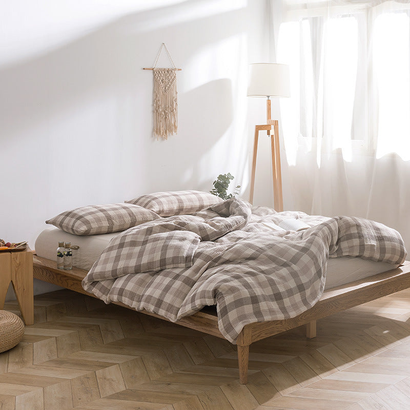 Beige plaid cotton gauze bedding set on wooden bed