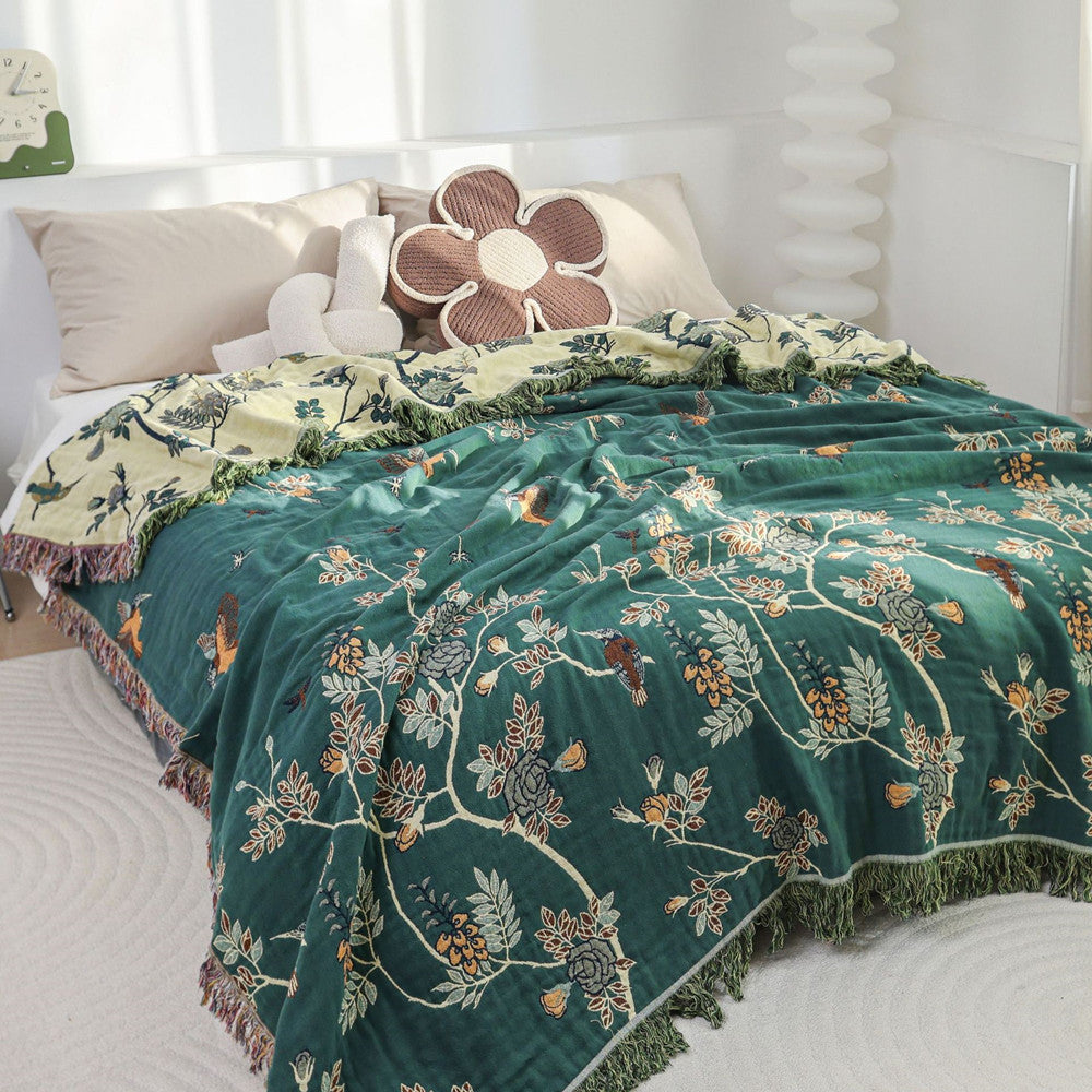 Hummingbird jacquard cotton blanket styled on a bed