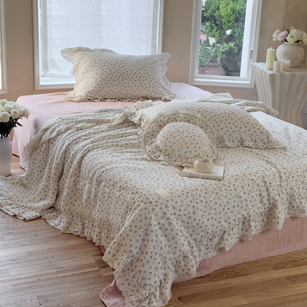 Ruffled cotton comforter layered with book and candle, perfect for a peaceful reading nook