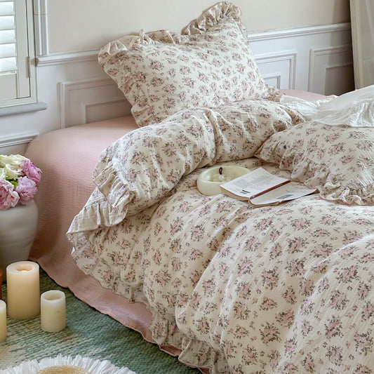 Full view of the Pink Floral Ruffled Duvet Cover on a white twin bed with light pink underlay, styled in a bright, rustic farmhouse bedroom with candles and shuttered windows.