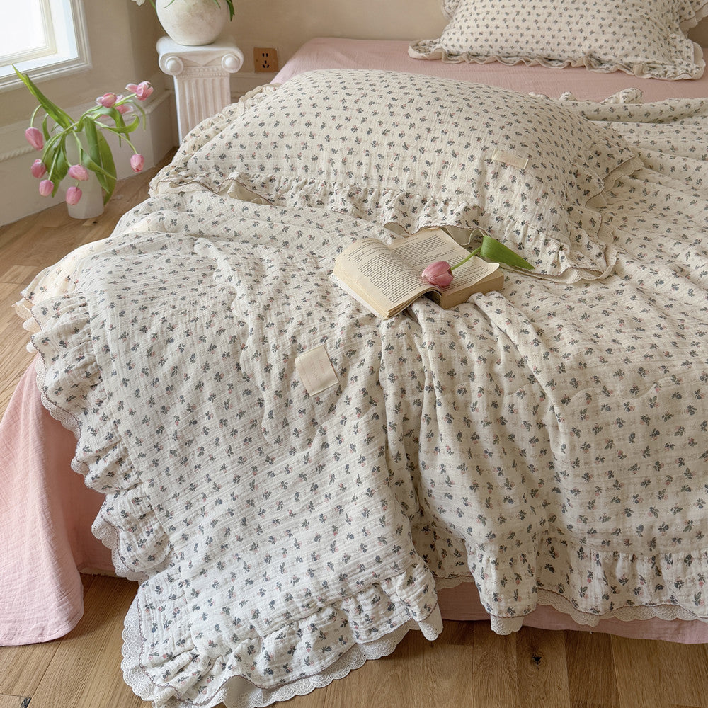 Ruffled Pink Rosebud Comforter with ruffled edge on wooden floor