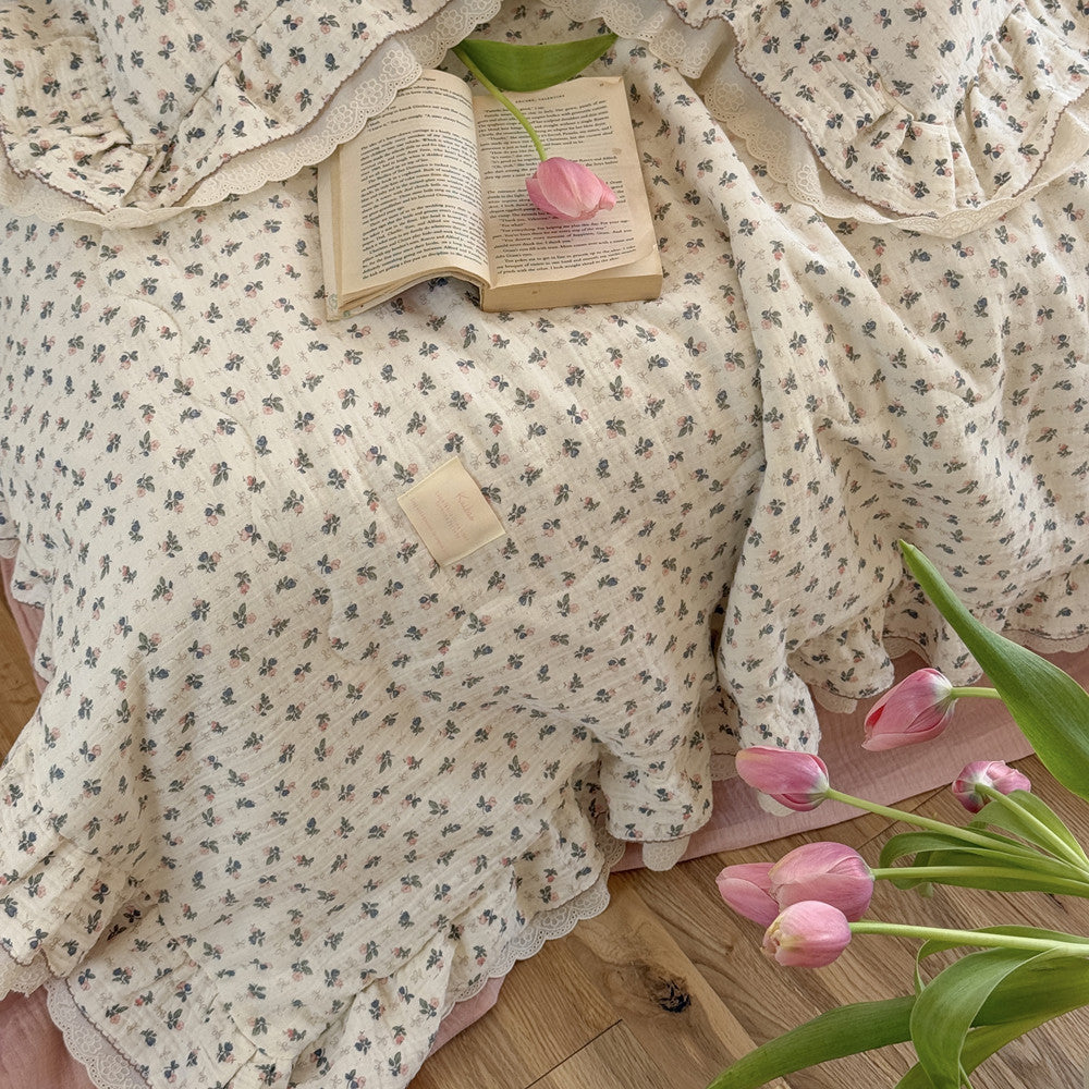 Close-up of pink floral gauze comforter with ruffle edge