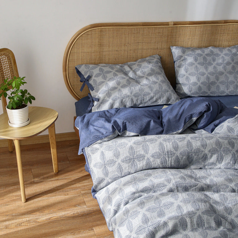 Pure Cotton Jacquard Bedding Set in blue and grey, showing the layered look and subtle leaf motif.