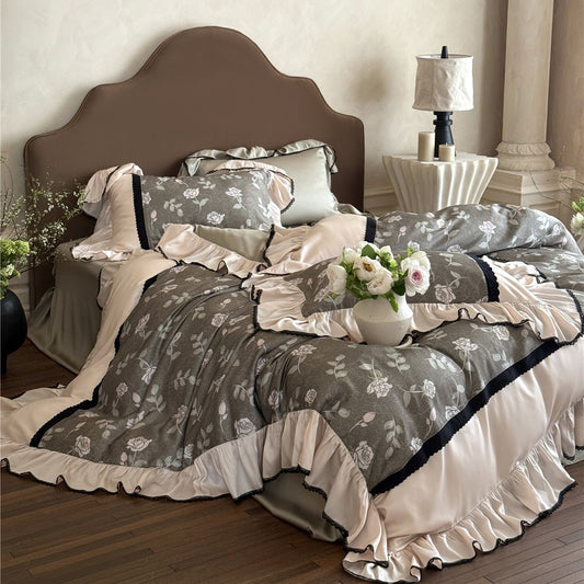 Romantic Olive Gray bedding set setup, featuring the floral duvet, ruffled trim, and a decorative vase of peonies on the bedside.