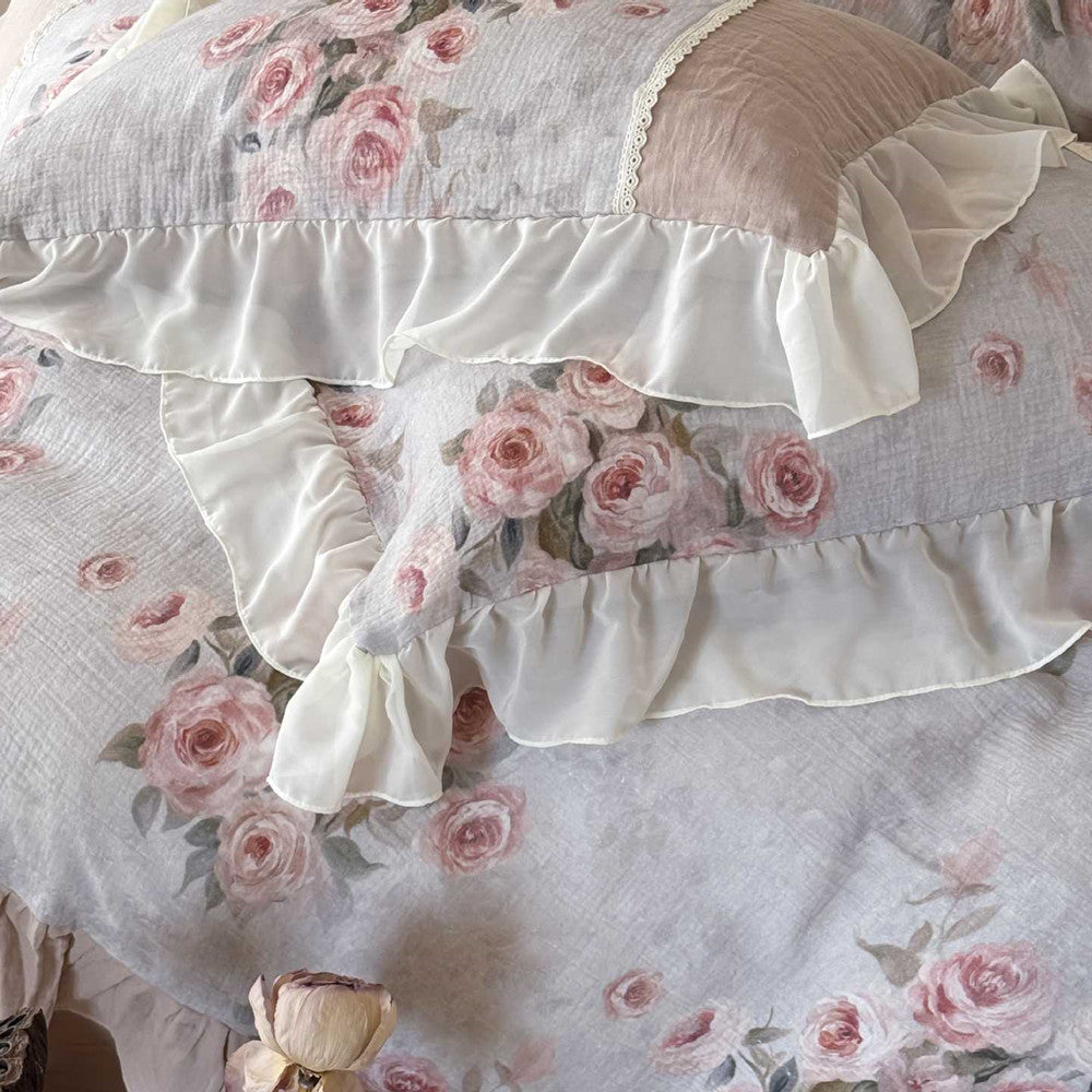 Close-up of vintage floral print and chiffon ruffle on romantic cotton gauze bedding