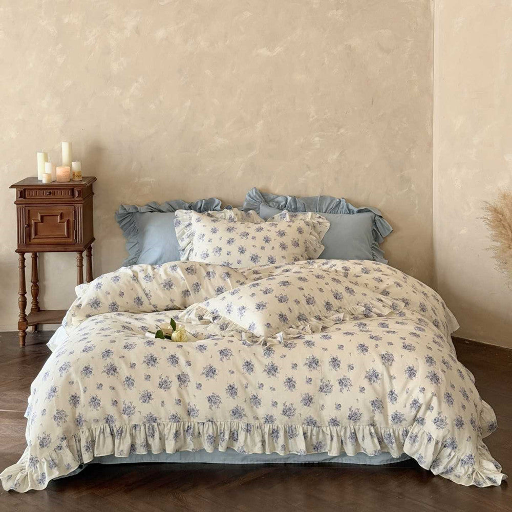 Blue floral cotton bedding set on a bed in a French Vintage/Cottagecore bedroom.