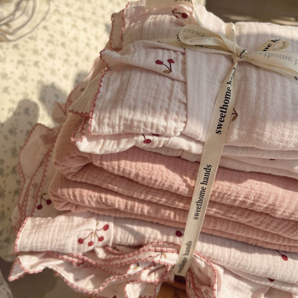 Stacked soft cotton gauze cherry print ruffle duvet cover set tied with a ribbon.