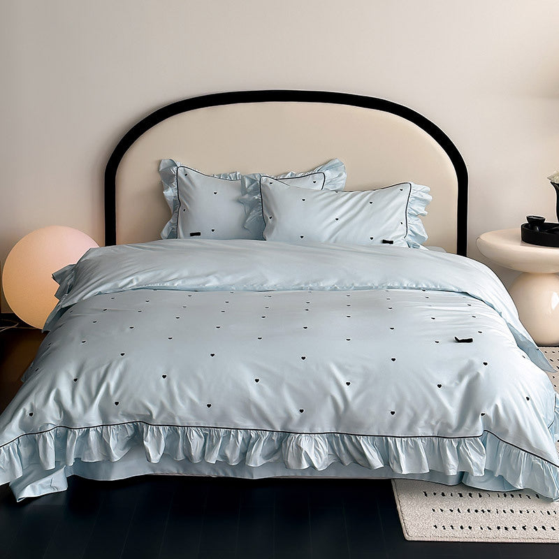 Full ruffled blue bedding set with heart embroidery – front view