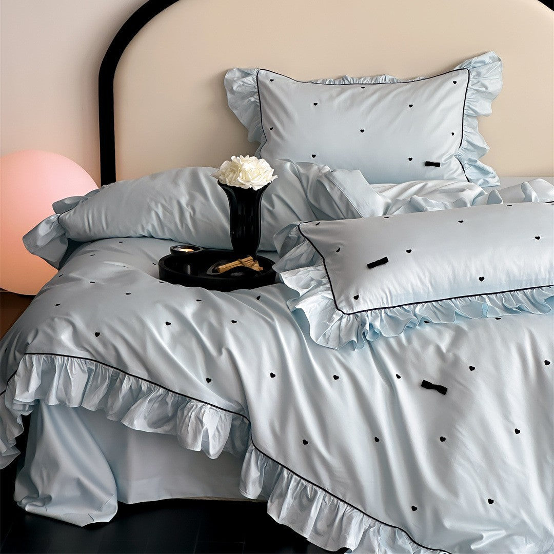 Main view of blue ruffled bedding set with heart details