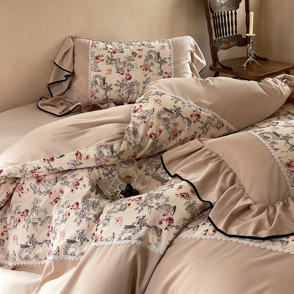 Side view of toile rose bedding with soft ruffles and floral detailing