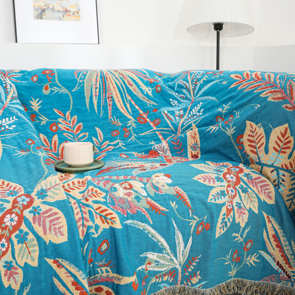 Tropical cotton throw blanket draped over a sofa