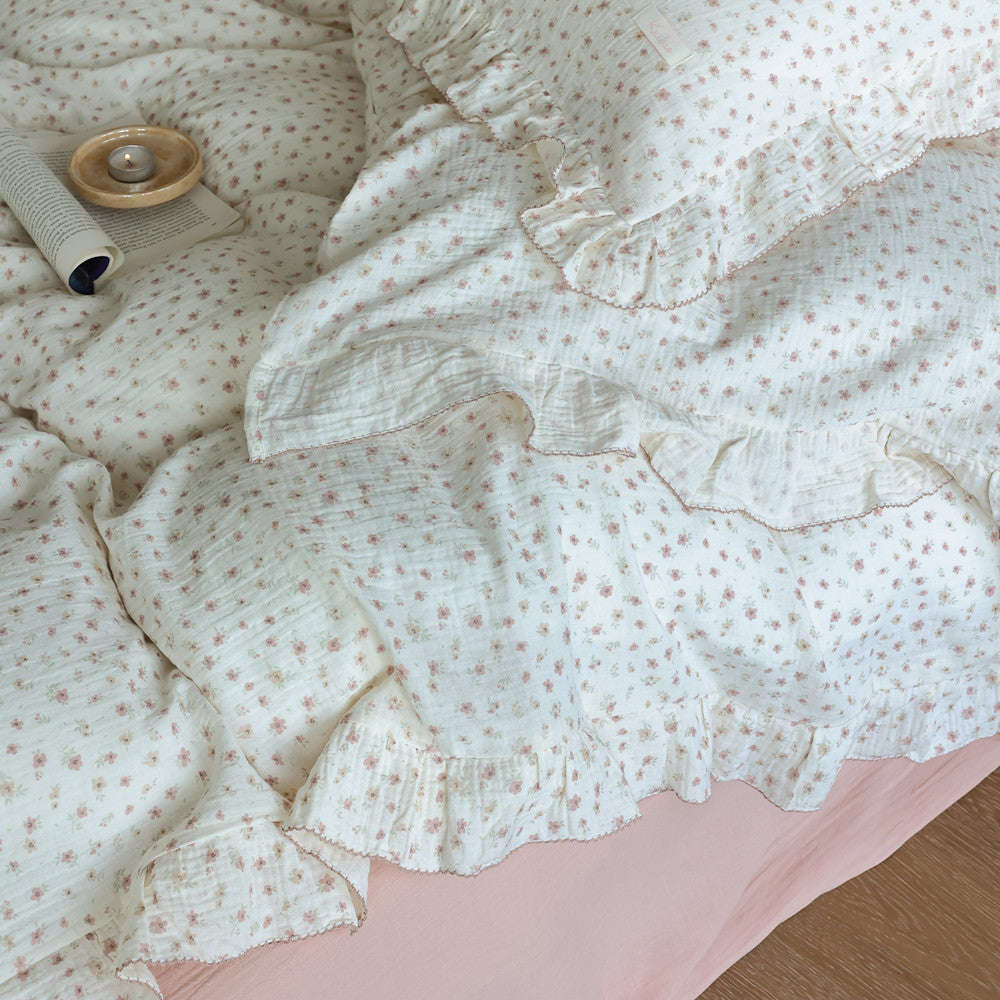 Ruffled floral twin duvet cover set with small pink flowers and solid pink sheet.