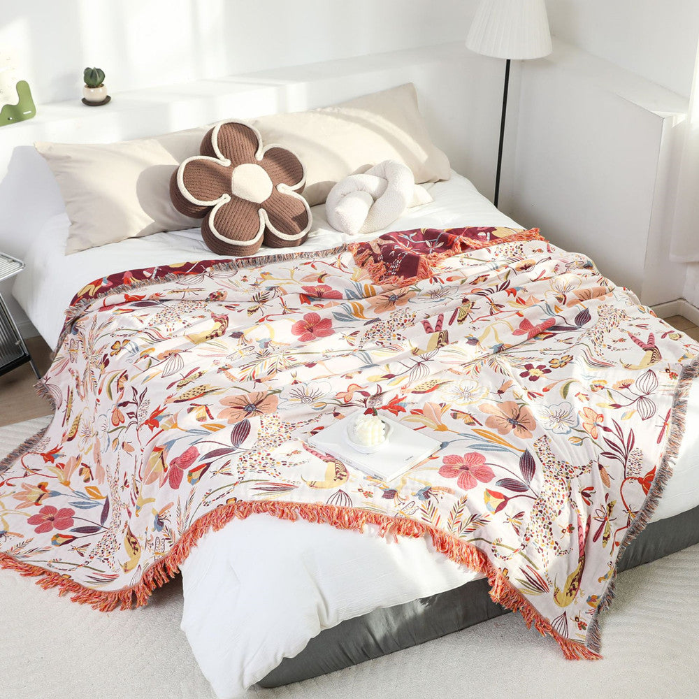 Wild garden jacquard throw styled on bed with sunlight