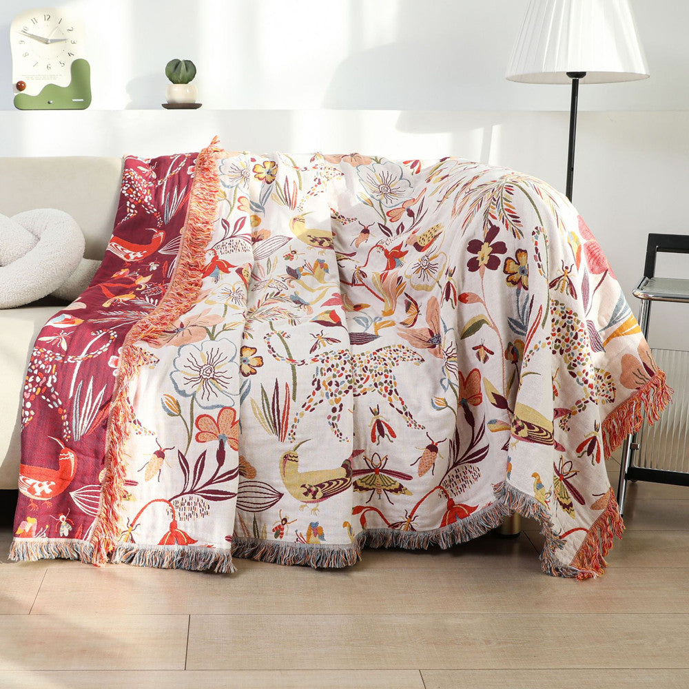 Blanket draped over sofa, reversible red side partially shown