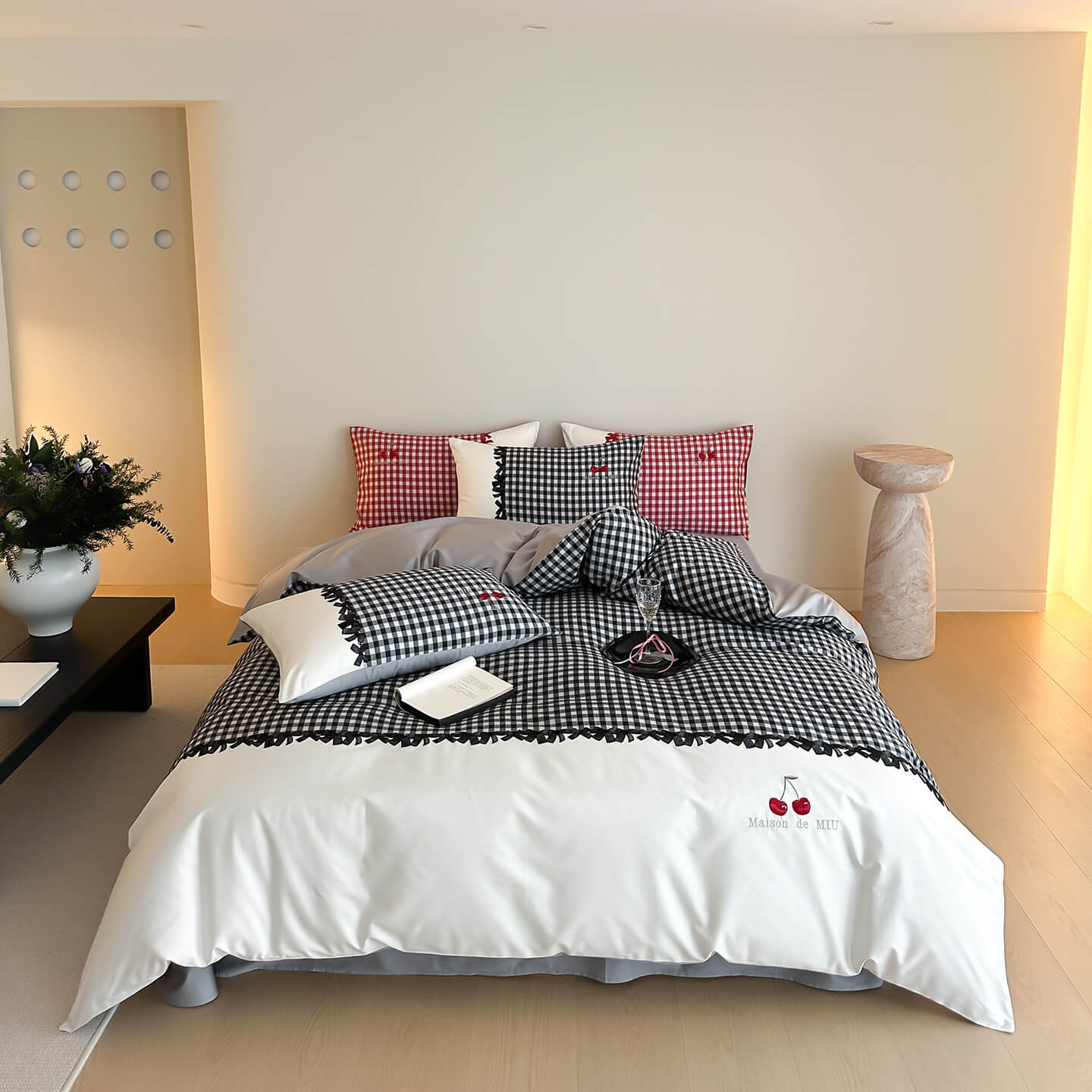Modern bedroom with black and white gingham cotton bedding set, red check pillows, and minimal decor