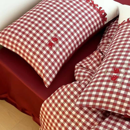 Red and white gingham cotton bedding set with embroidered cherries on soft sheets from StuffedHome
