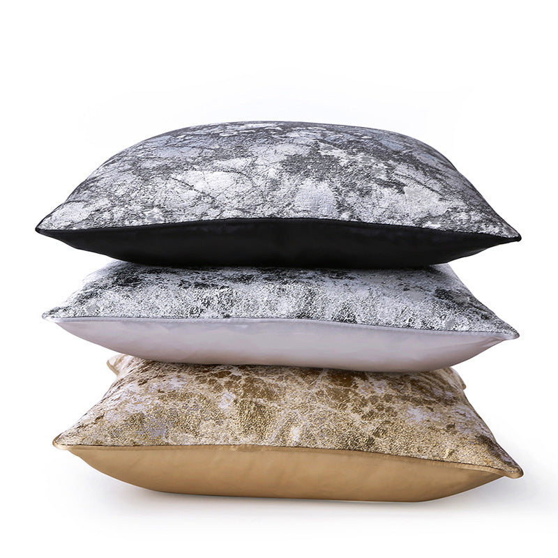 Stack of three abstract textured modern decorative pillow covers in metallic black, silver, and gold from StuffedHome