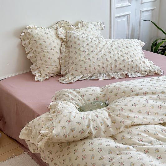 Floral bedding set on a bed with a white headboard
