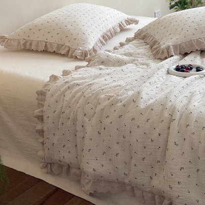 Pastoral design blueberry printed cotton gauze pillows with matching ruffled lace trim comforter, featuring a decorative white plate of fresh berries in a minimalist sunlit bedroom.