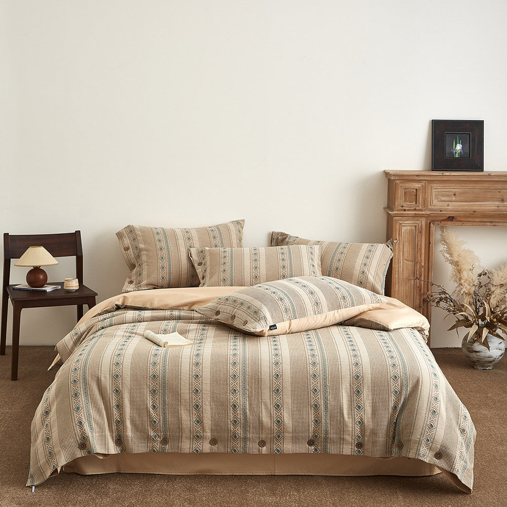 Boho cotton jacquard bedding set with beige and green geometric pattern in cozy bedroom