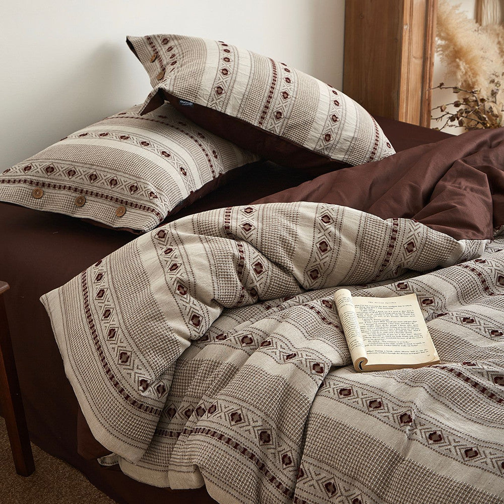 Boho cotton jacquard bedding set with patterned duvet cover and pillows on a brown bed