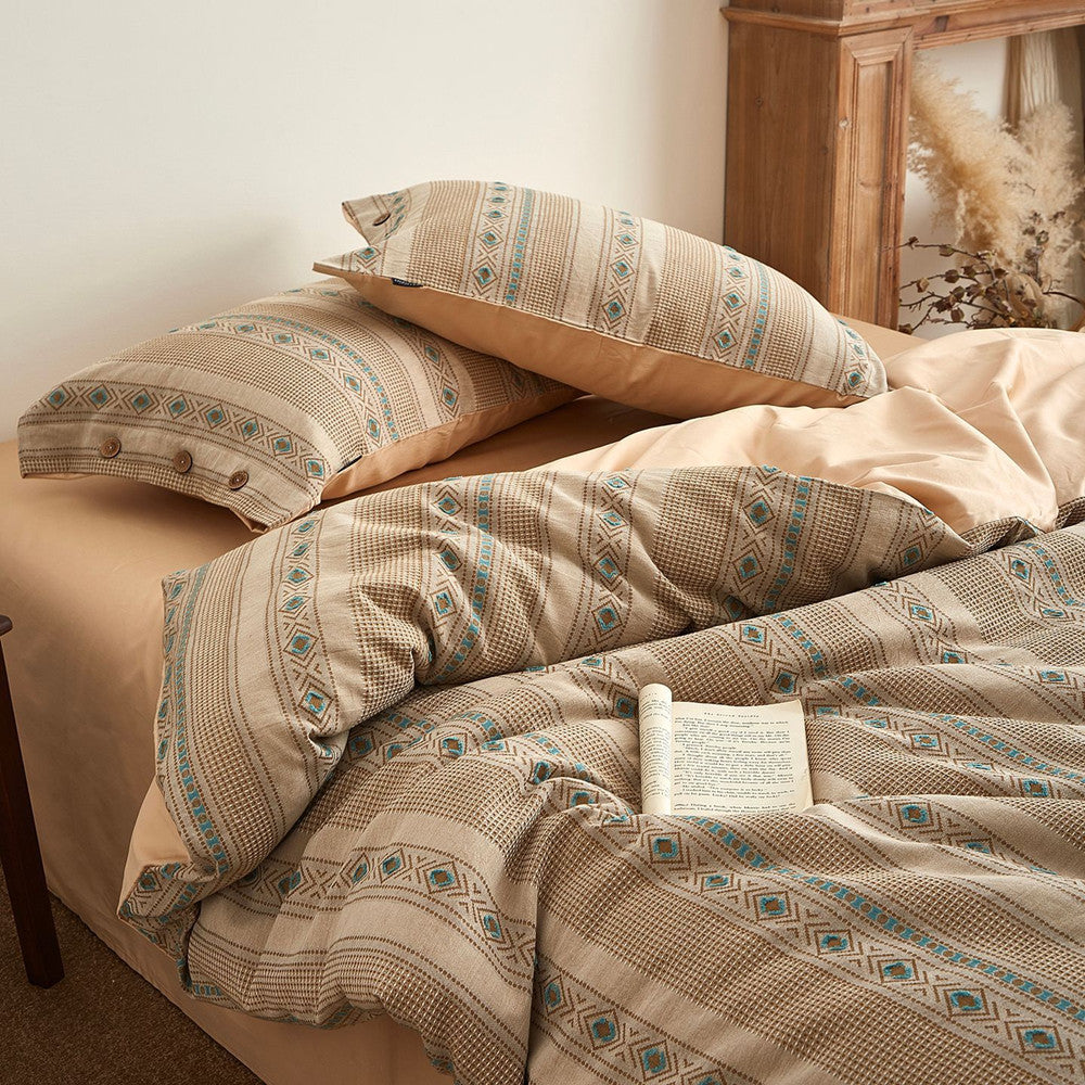 Boho cotton jacquard bedding set with beige and blue geometric patterns on a cozy bed