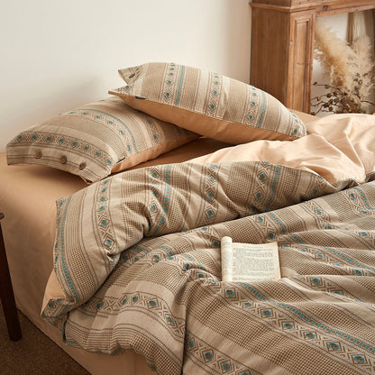 Boho cotton jacquard bedding set with beige and blue geometric patterns on a cozy bed