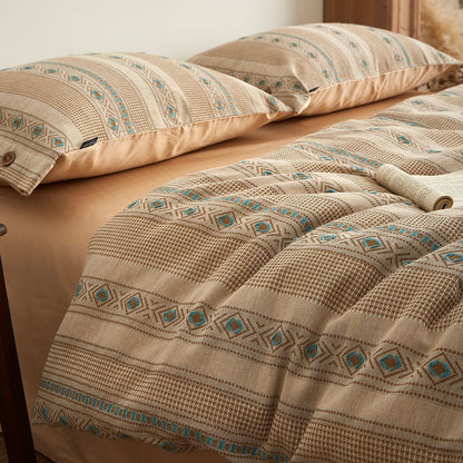 Boho cotton jacquard bedding set with beige, blue and geometric patterns on a bed