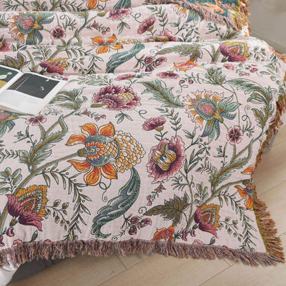 Close-up of boho floral cotton throw blanket with woven vine and flower details