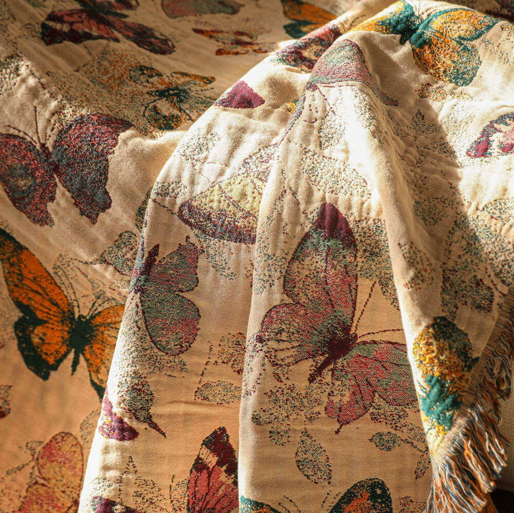 Close-up of butterfly cotton throw blanket showing woven texture and multicolor butterfly pattern