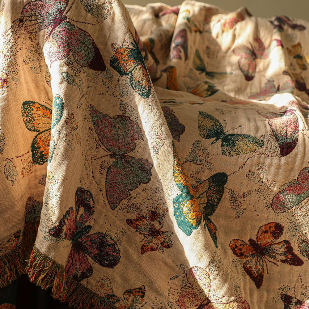 Butterfly cotton throw blanket with fringe and warm beige woven fabric detail