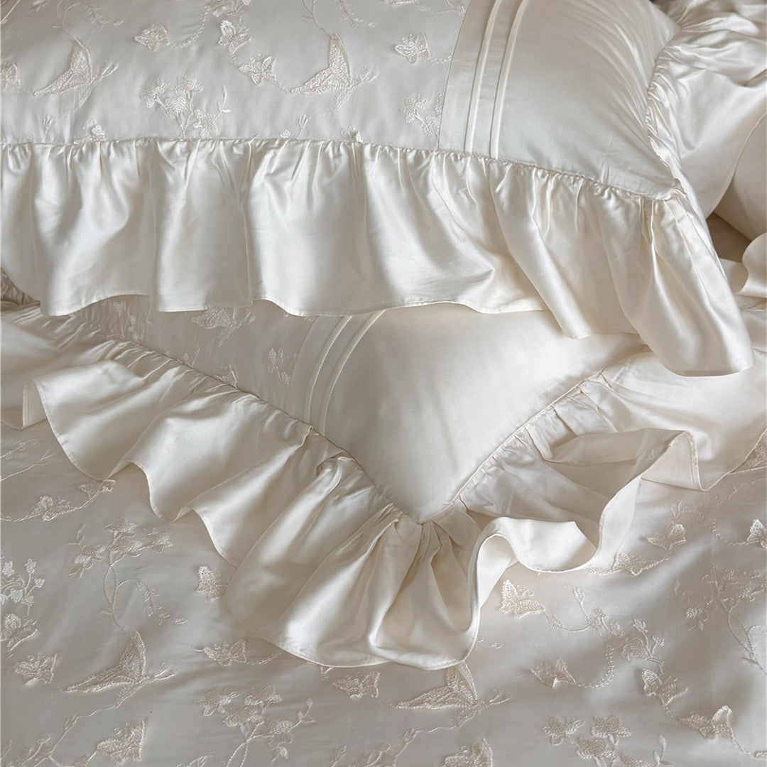 Close-up of two stacked pillows from the Butterfly Embroidered Bedding Set showing the butterfly embroidery and ruffles.