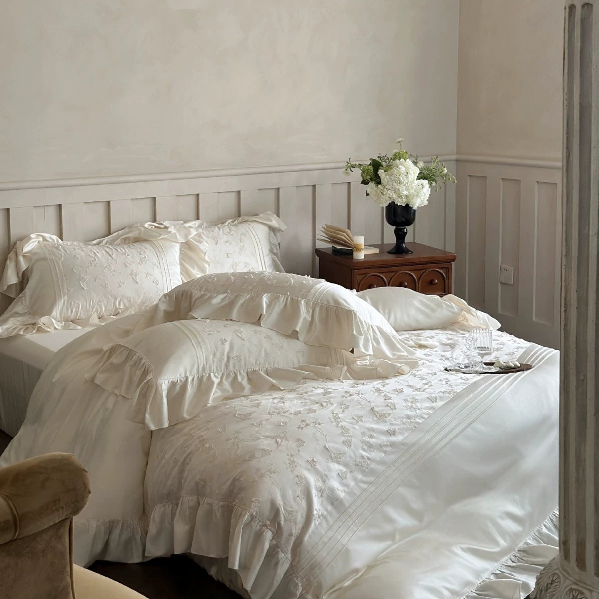 Full view of the cream-colored Butterfly Embroidered Bedding Set with ruffles, styled in a bright bedroom.