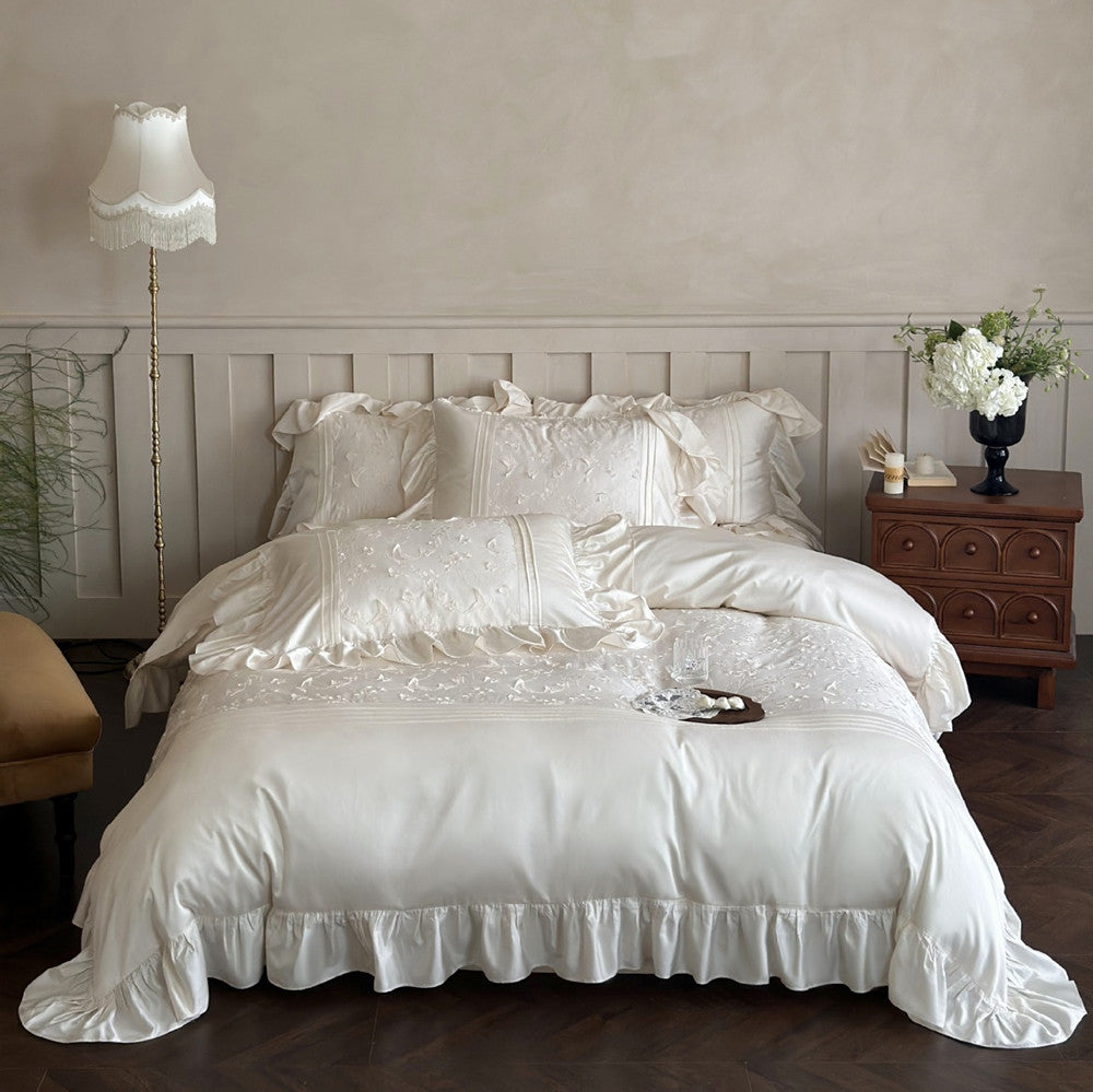 Luxurious Butterfly Embroidered Bedding Set with large ruffles on a bed in an elegant bedroom.