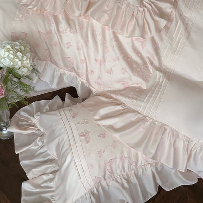 Overhead view of the pink Butterfly Embroidered Bedding Set highlighting the butterfly embroidery and wide ruffles.