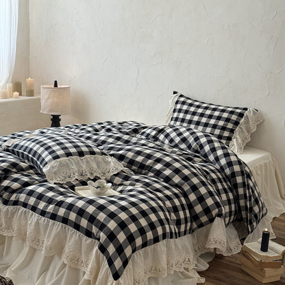 Bed with black and white checkered bedding and lace details in a bedroom setting.