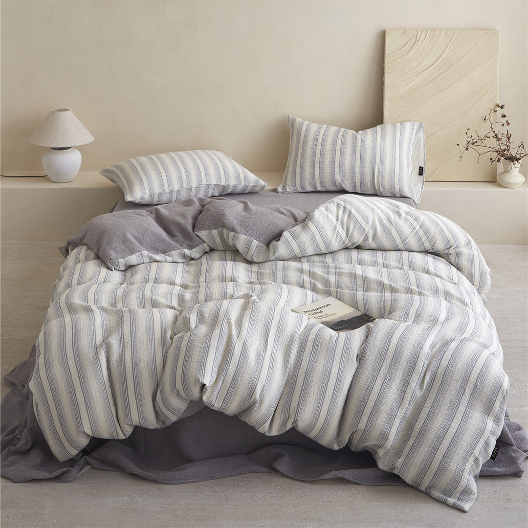 Full view of the Smoky Gray Striped Cotton Gauze Bedding Set, showing the reversible solid gray sheet and minimalist styling.