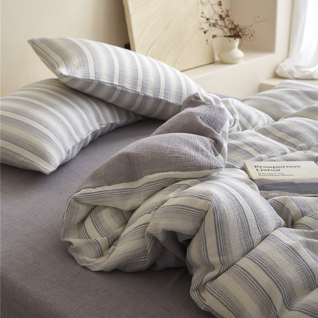 Close-up of the Smoky Gray Striped duvet cover fold, highlighting the stripe and the solid charcoal reverse side.