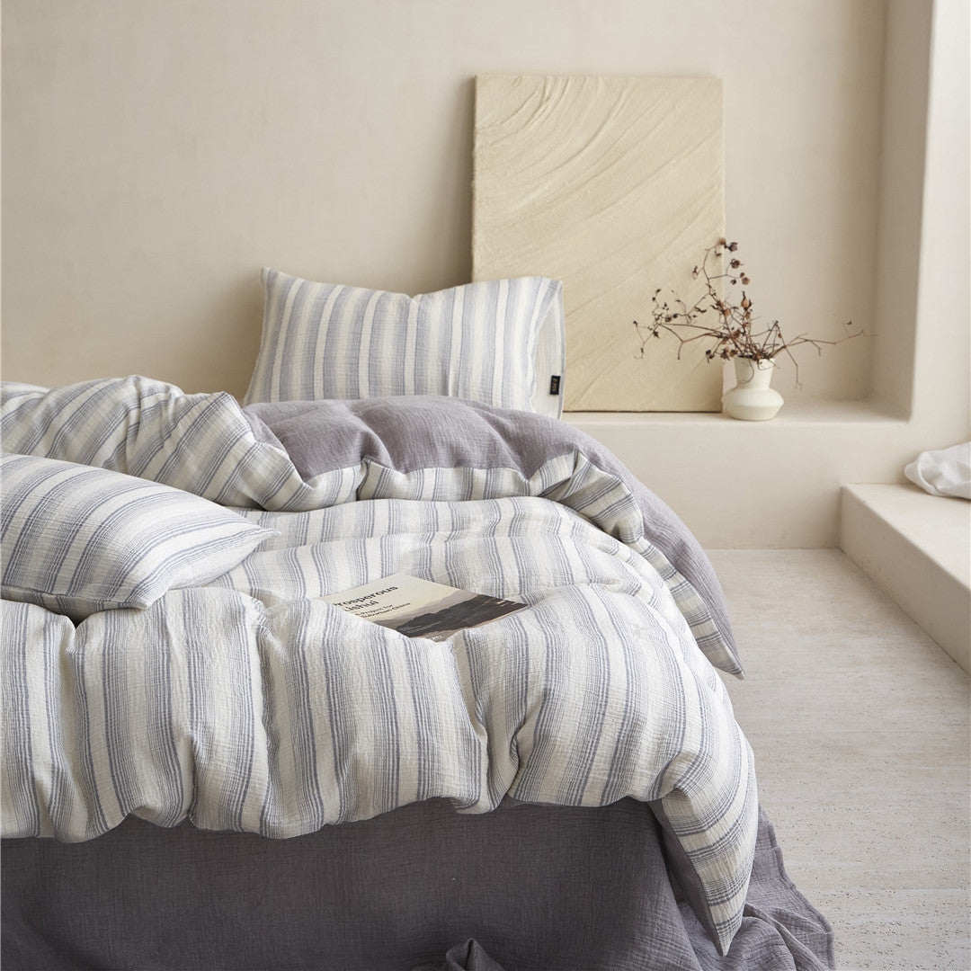 Full-bed styled view of the Smoky Gray Striped Bedding Set, emphasizing the clean lines and modern, reversible design.