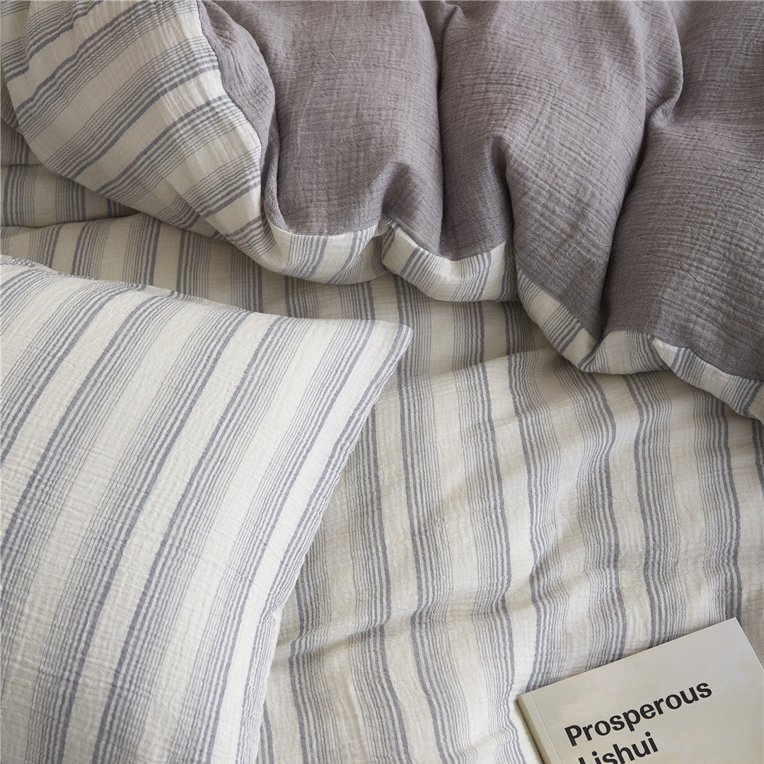 Overhead close-up of the Smoky Gray Stripe pillow and duvet cover, detailing the thin gray stripes on a cream background.
