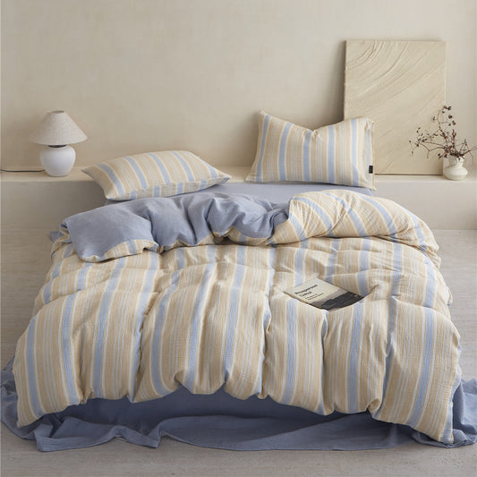 High-quality image of the Yellow & Blue Striped Duvet Cover Set, emphasizing the soft folds and the coordinating solid blue fitted sheet.