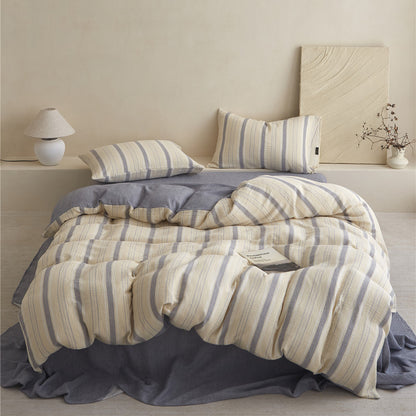 Styled full view of the beige & grey Striped Duvet Set (Duvet Cover, Sheet, Shams) on a minimalist bed.